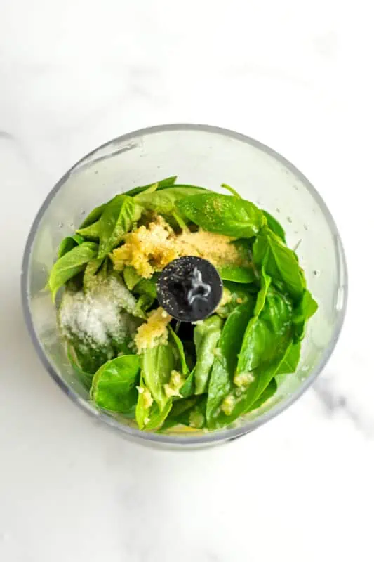 Basil, garlic powder and salt in food processor.