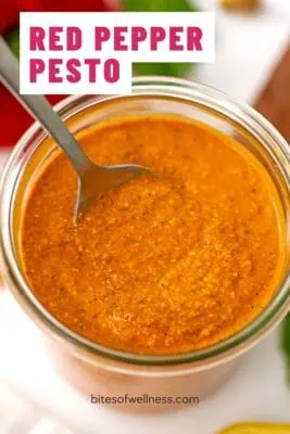 Large glass jar of roasted red pepper pesto.