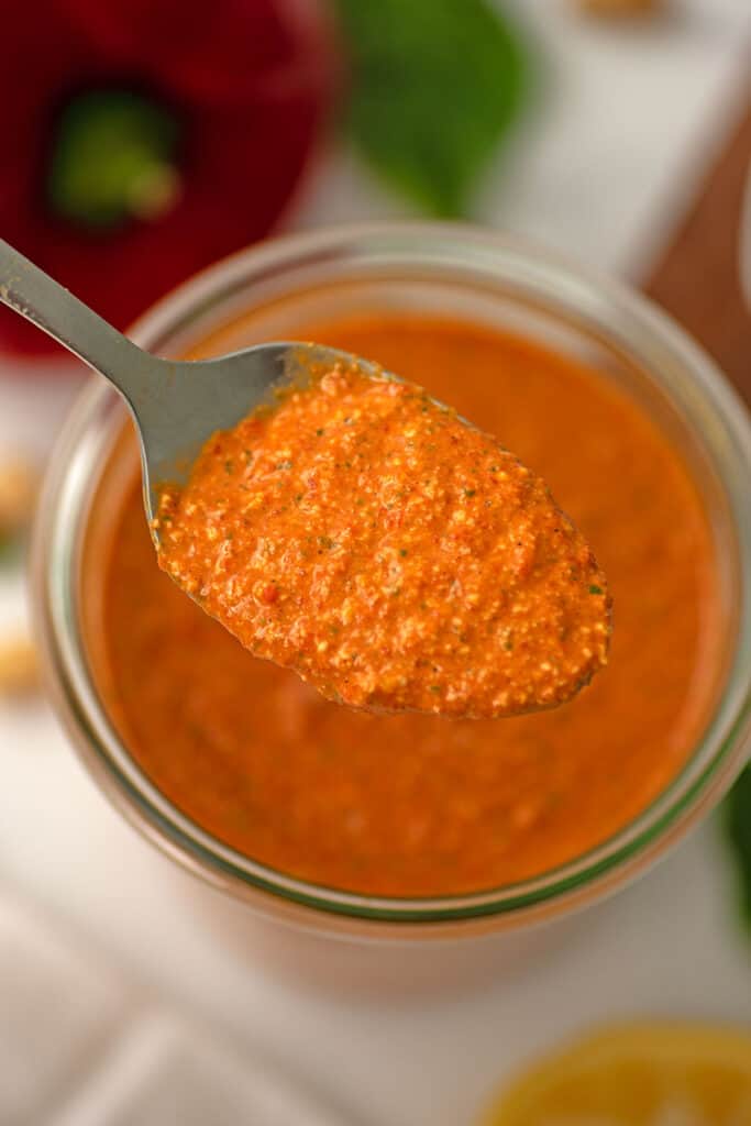 Large spoonful of red pepper pesto.