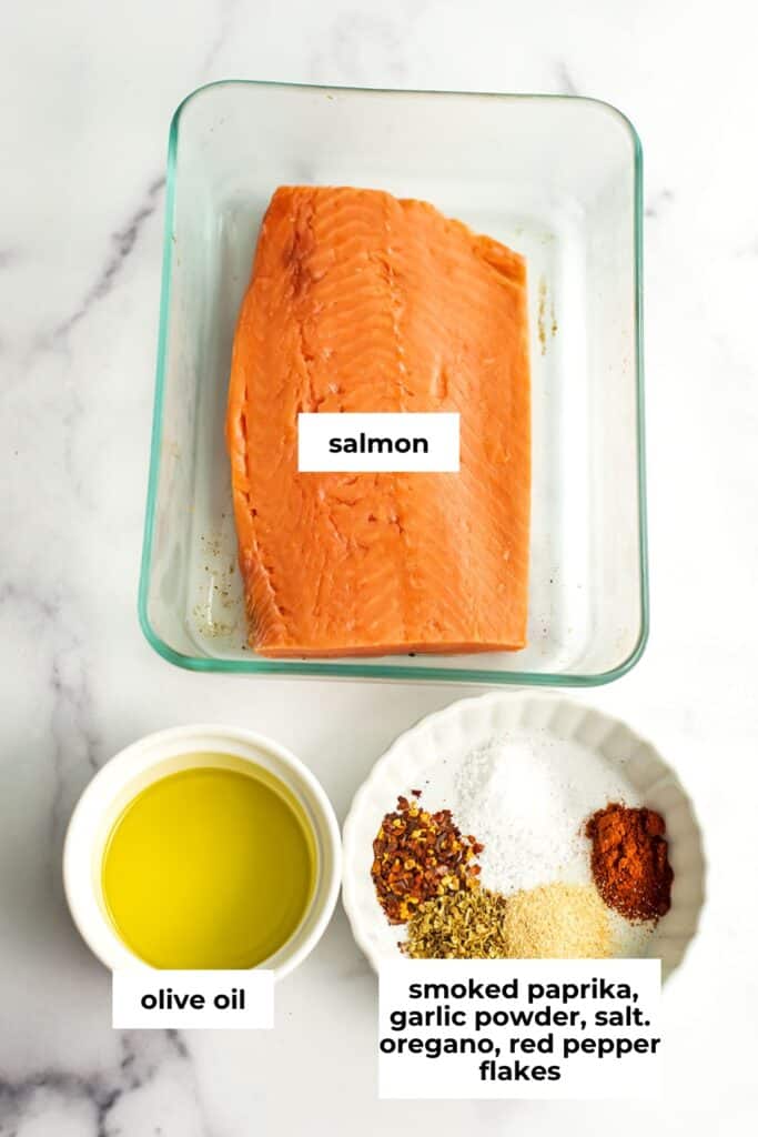 Ingredients to make air fried salmon bites on marble countertop.