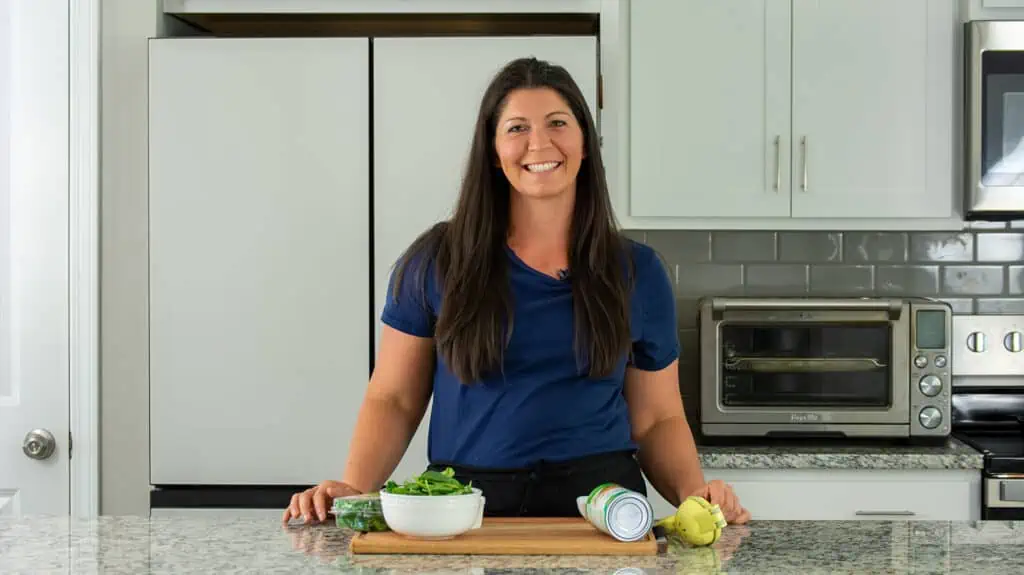 Samantha Rowland standing in front of her kitchen on set for her youtube channel.