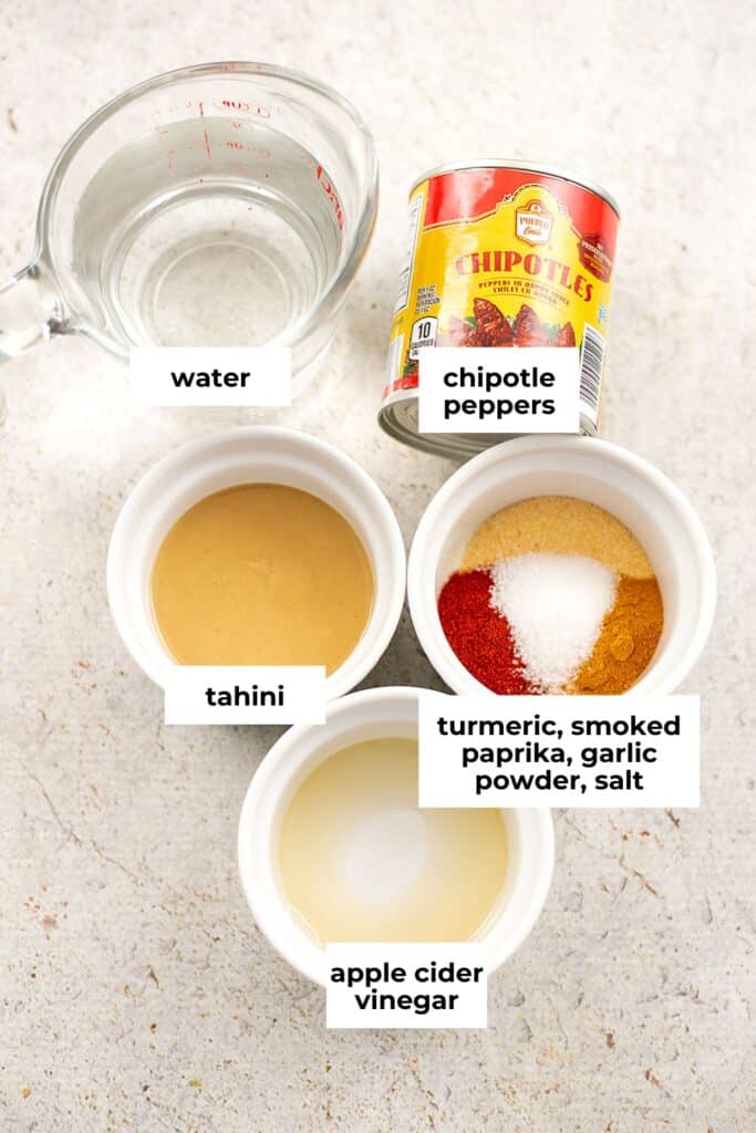 Ingredients to make spicy tahini sauce in ramekins.