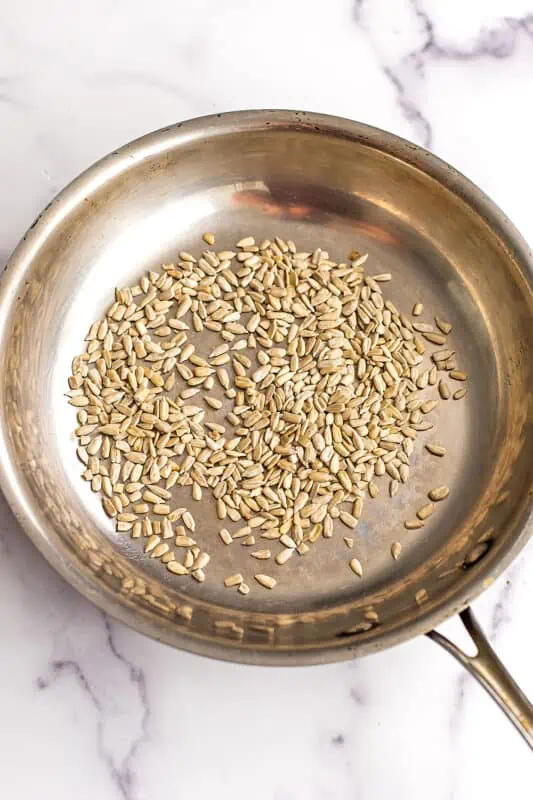 Raw sunflower seeds in skillet.