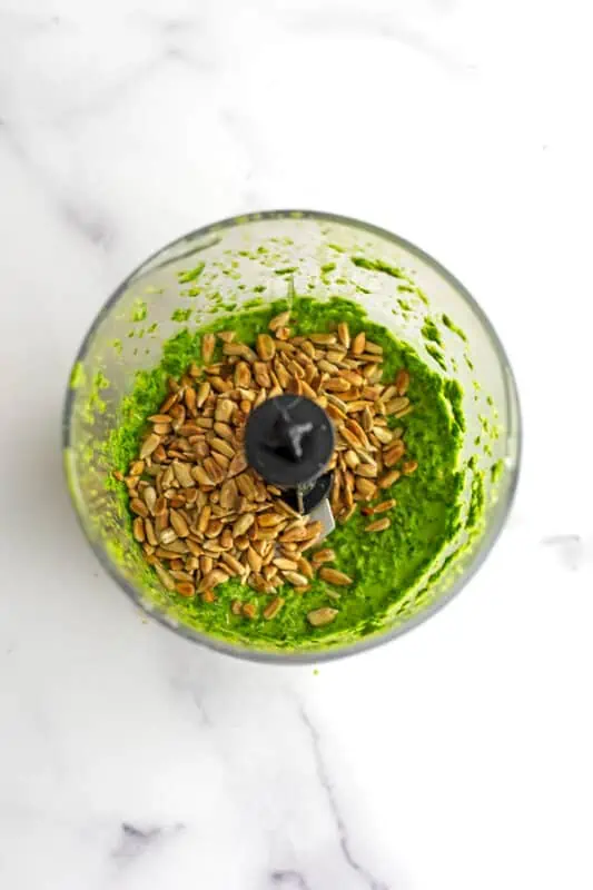 Toasted sunflower seeds added to food processor.