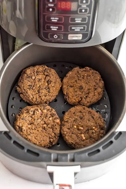 Black bean burgers in air fryer after cooking.