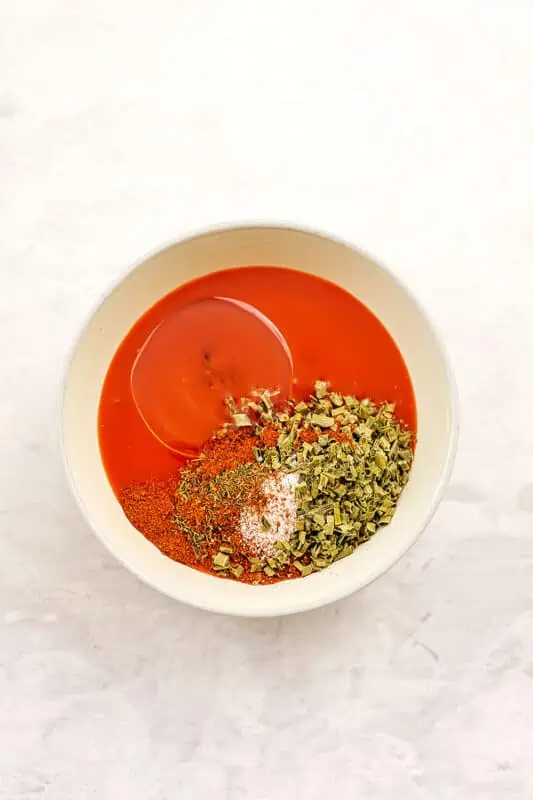 Ingredients to make buffalo sauce in a bowl.