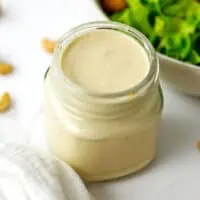 Small glass jar filled with caesar cashew dressing.