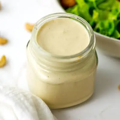 Small glass jar filled with caesar cashew dressing.