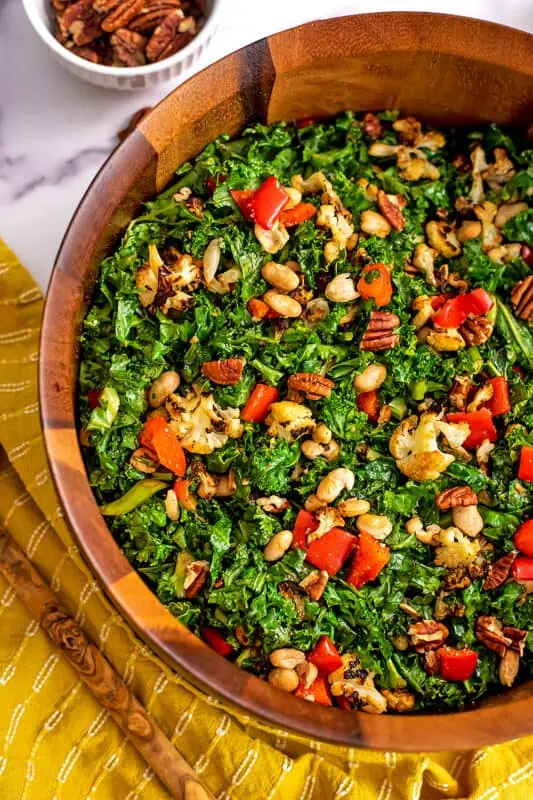 Cauliflower kale salad in a large wood salad bowl.