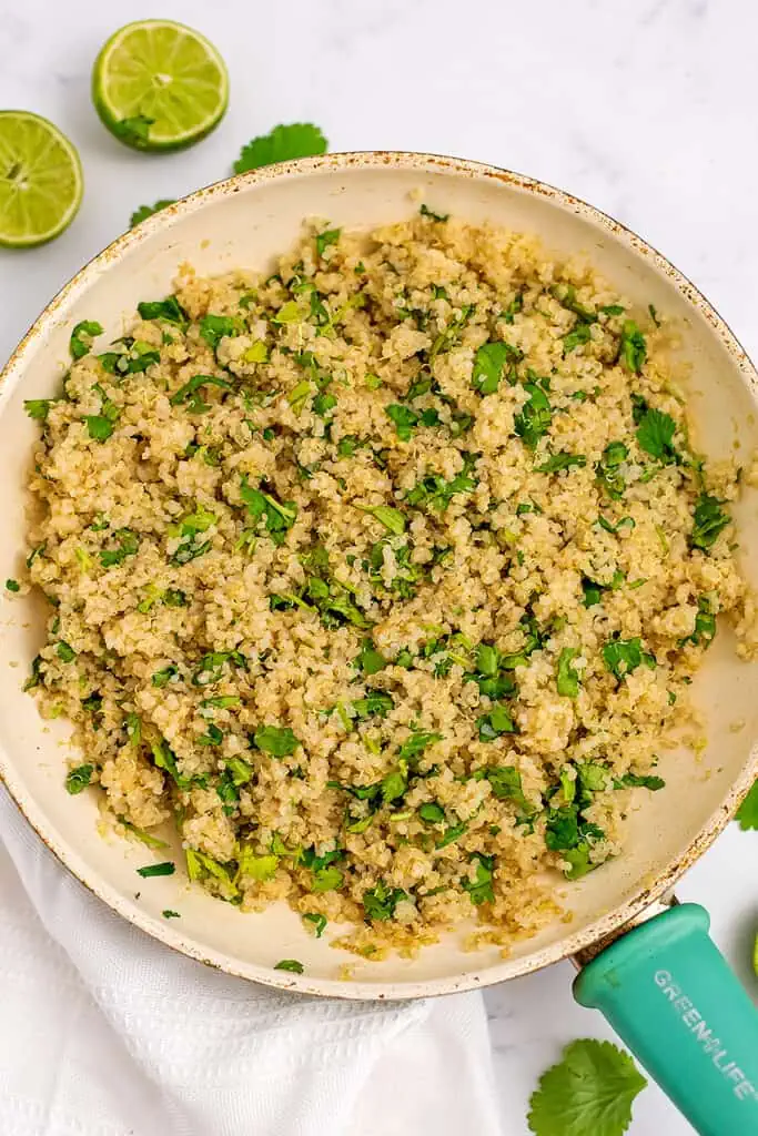 Cilantro lime quinoa after stirring in skillet.