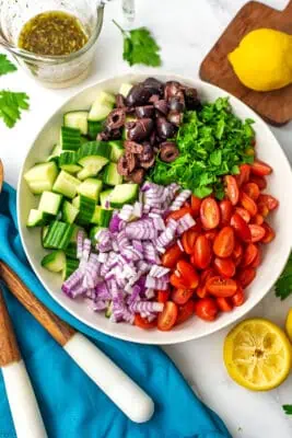 Mediterranean cucumber tomato salad in a white bowl.