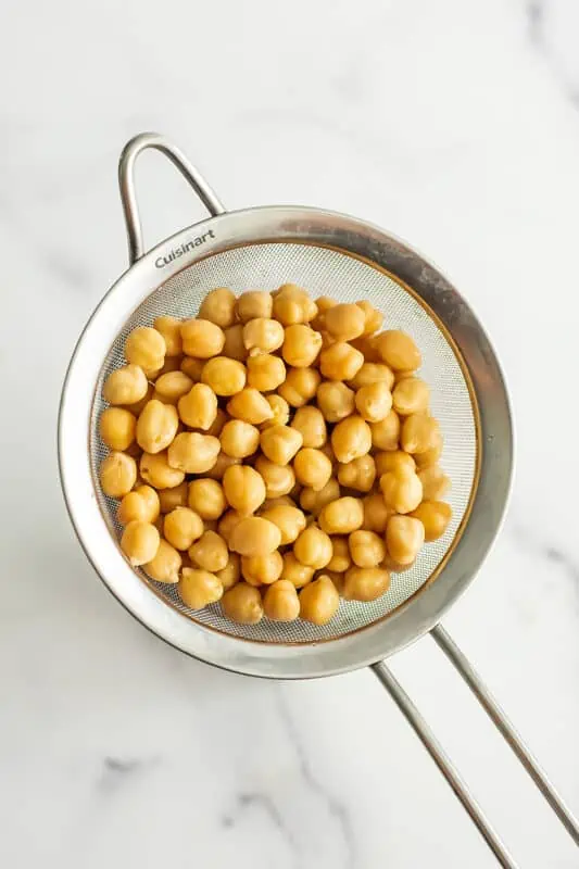 Chickpeas in a mesh strainer.