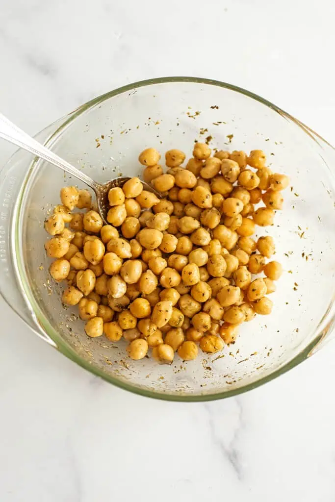 Chickpeas in a bowl mixed with spices.