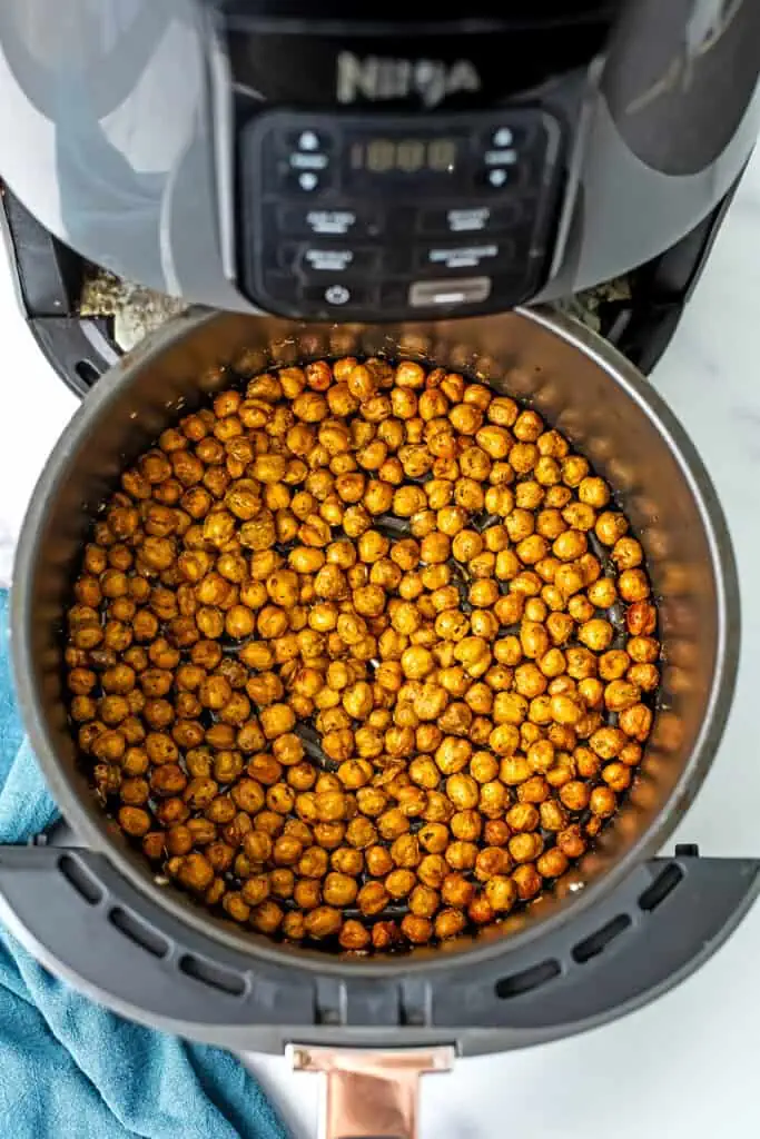 Overhead view of air fryer chickpeas in the basket of an air fryer.