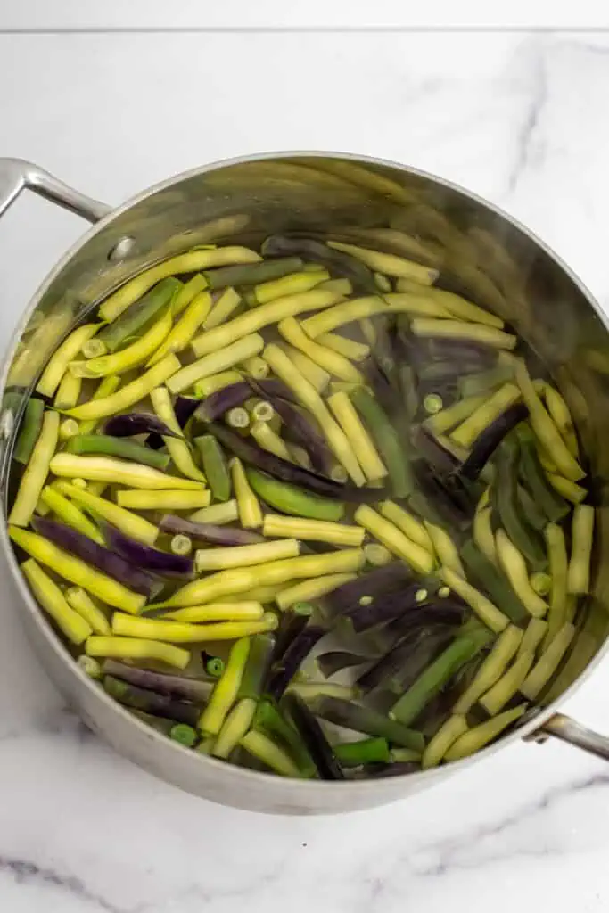 Green beans boiling in a pot of water.