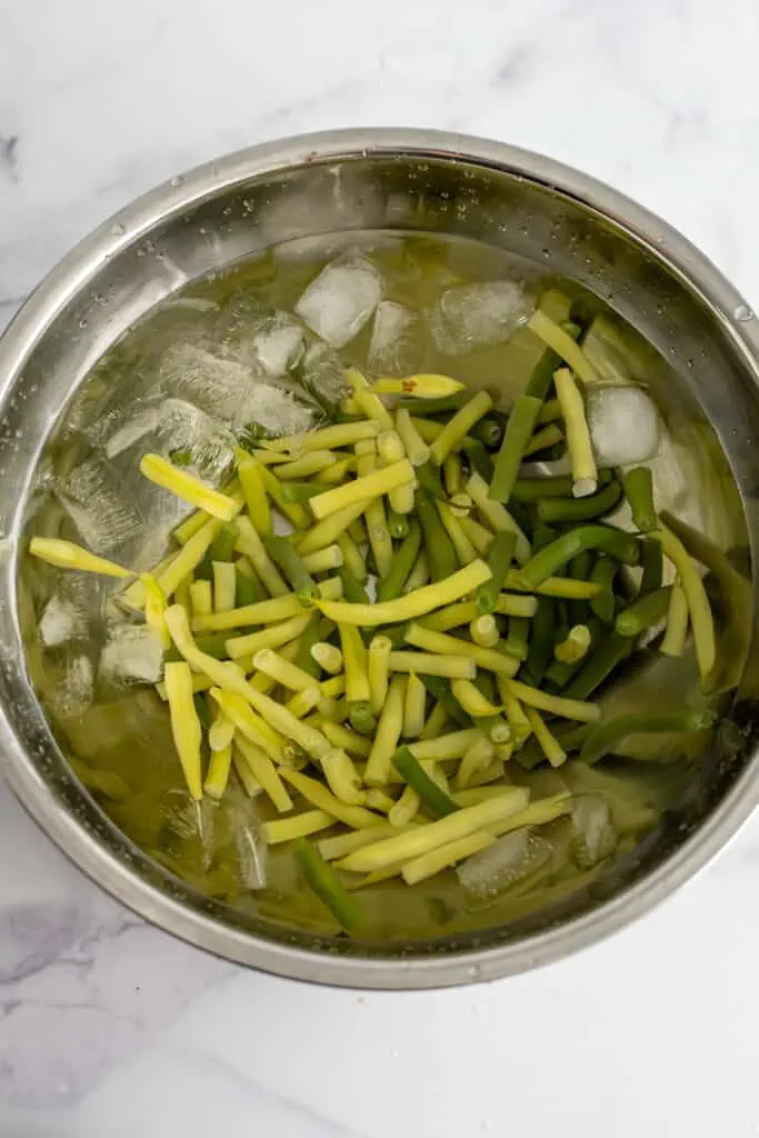 Chopped green beans soaking in an ice bath.