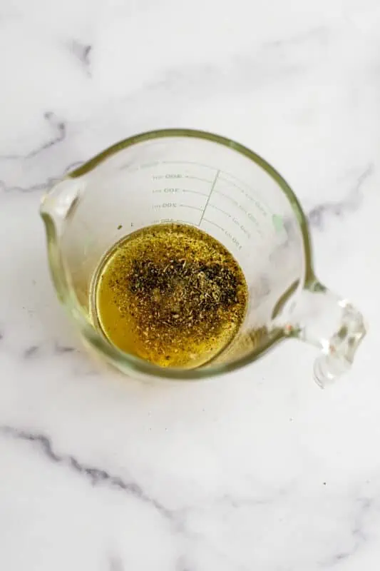 Italian dressing ingredients in a measuring cup.