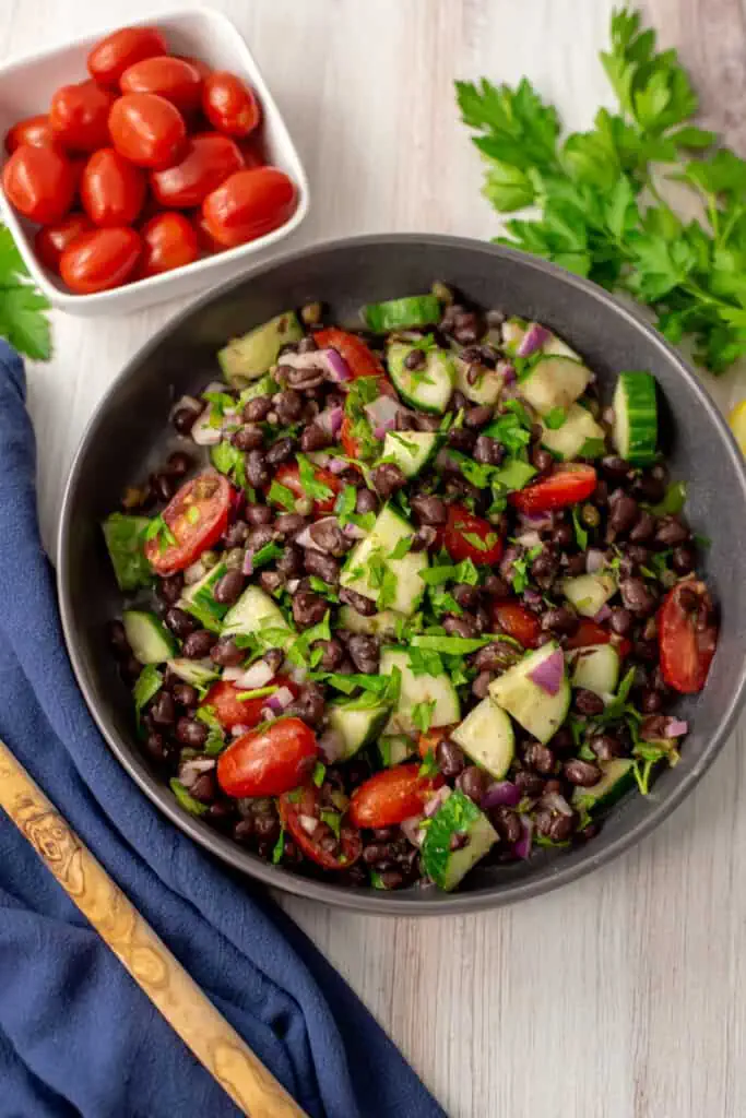 Mediterranean black bean salad in a gray bowl.