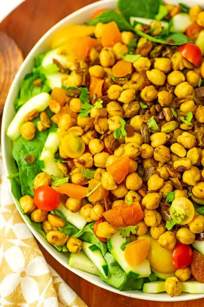 A Moroccan chickpea salad in a large wide white bowl.