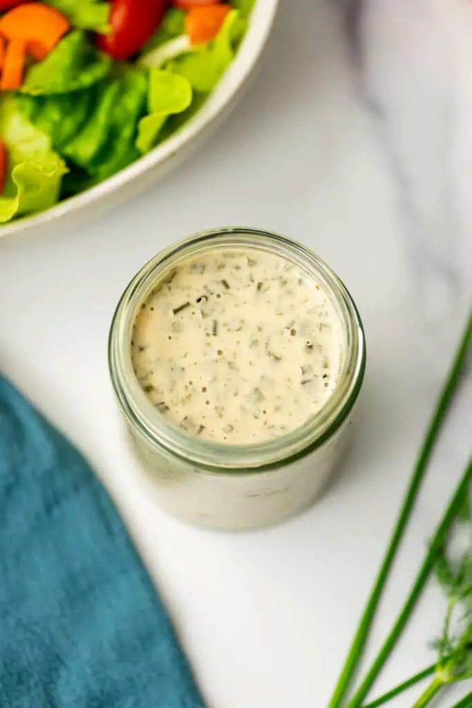 Tahini ranch dressing in a small glass container.