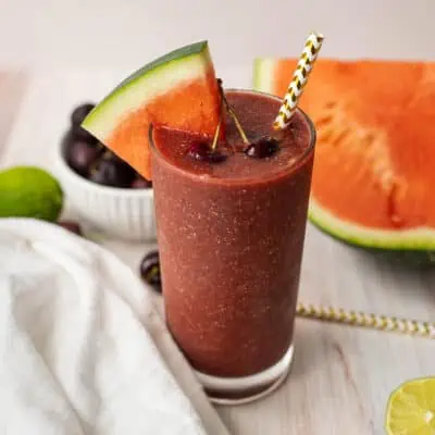 Watermelon cherry smoothie with watermelon wedge.