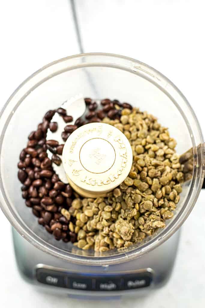 Cooked lentils and black beans in food processor.