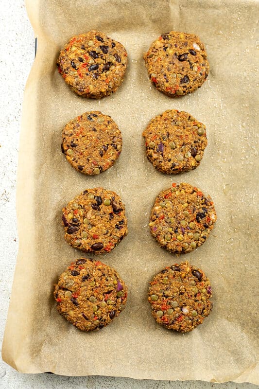 Sheet pan with black bean lentil burgers before cooking.