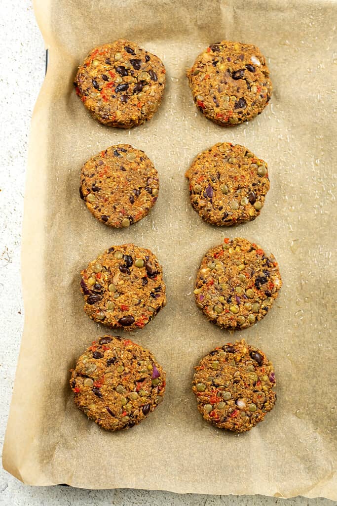 Sheet pan with black bean lentil burgers before cooking.