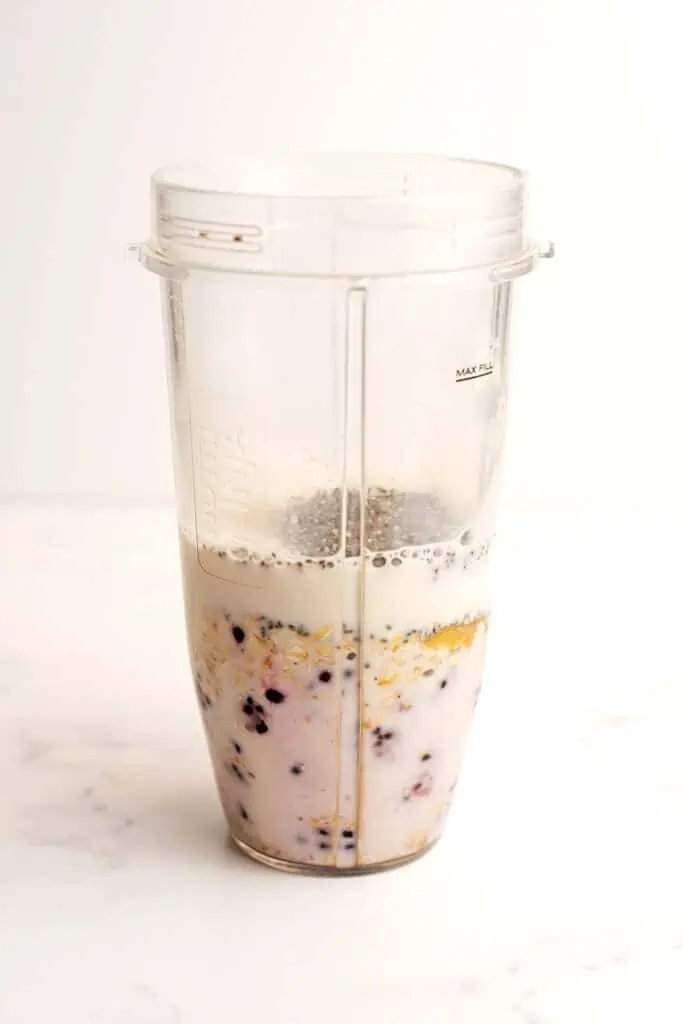 Blackberry Oatmeal Smoothie ingredients combined in blender cup before being blended.