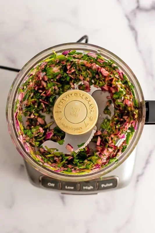 Red onion, jalapeno and cilantro processed in a food processor.