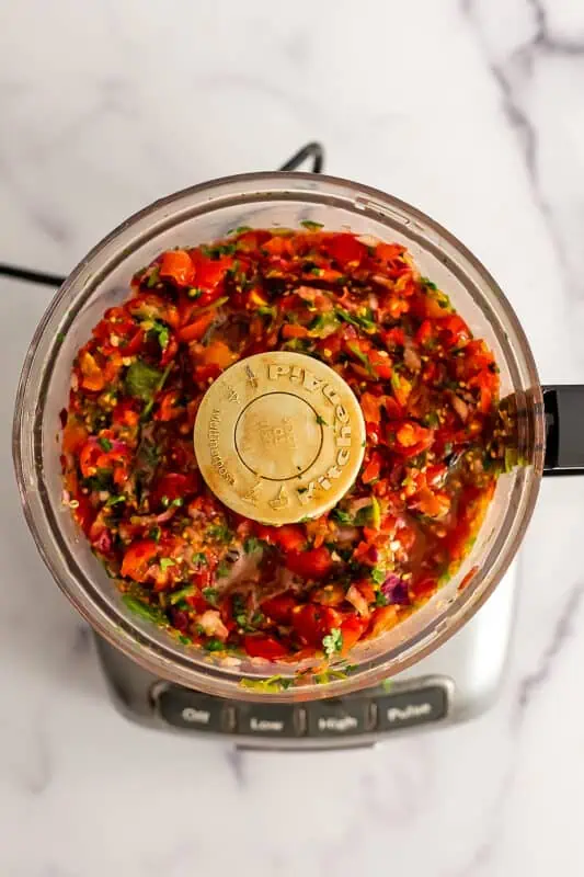 Cherry tomato salsa in a food processor.