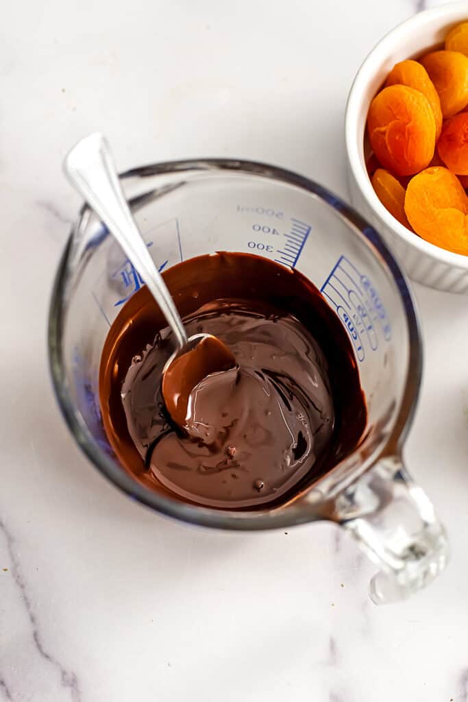 Melted chocolate and tahini in a measuring cup.