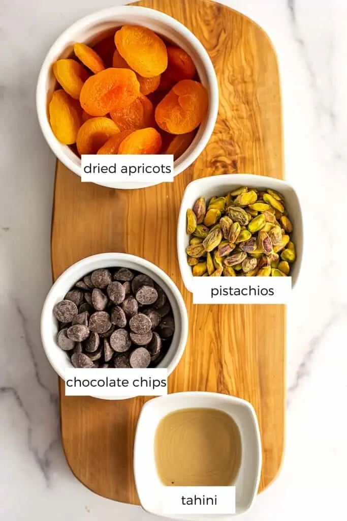 Chocolate covered apricot ingredients in white ramekins.
