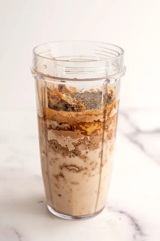 Chocolate Tahini Smoothie ingredients in a bullet blender cup before being blended.