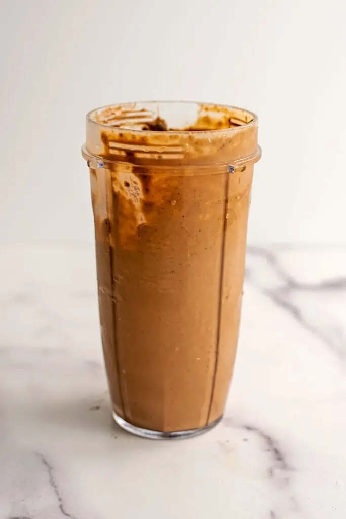 A Chocolate Tahini Smoothie in a bullet blender cup after all the ingredients have been blended.