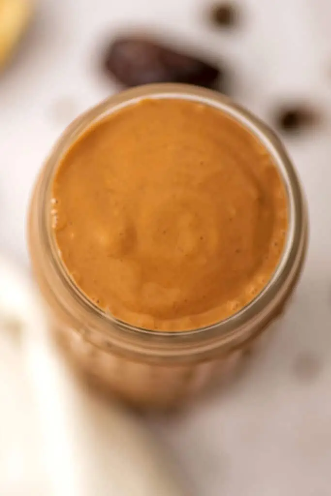 An overhead shot of a Chocolate Tahini Smoothie in a glass.