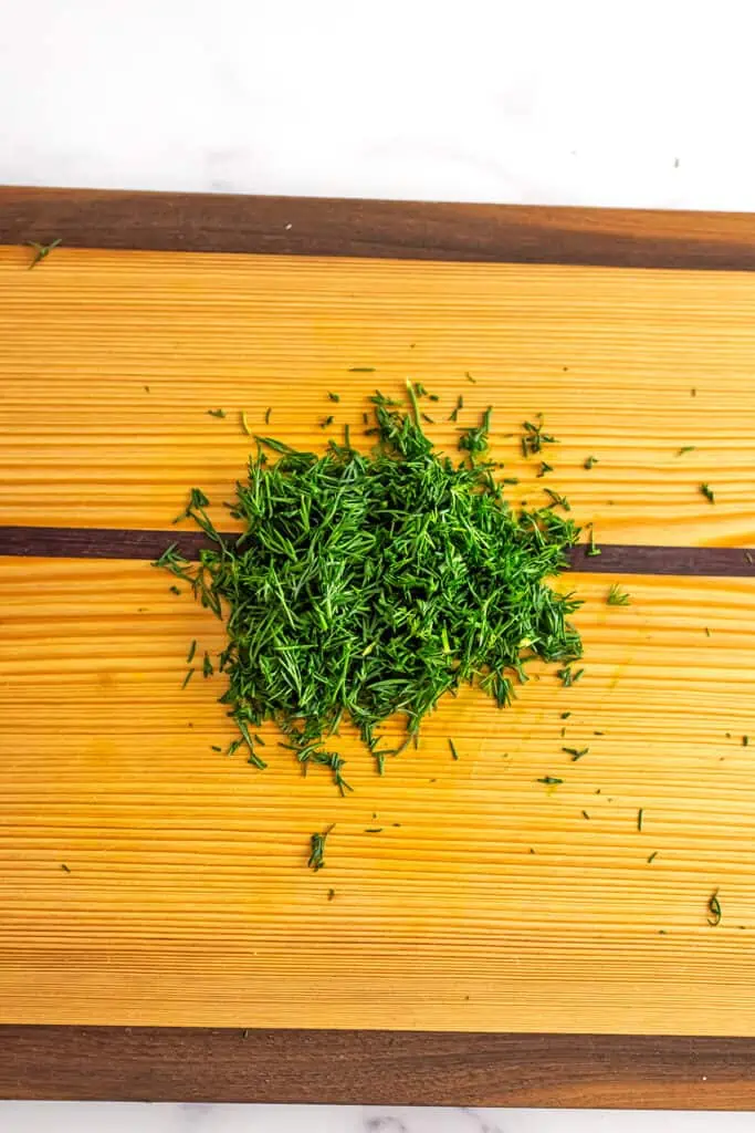 Dill finely chopped on a cutting board. 