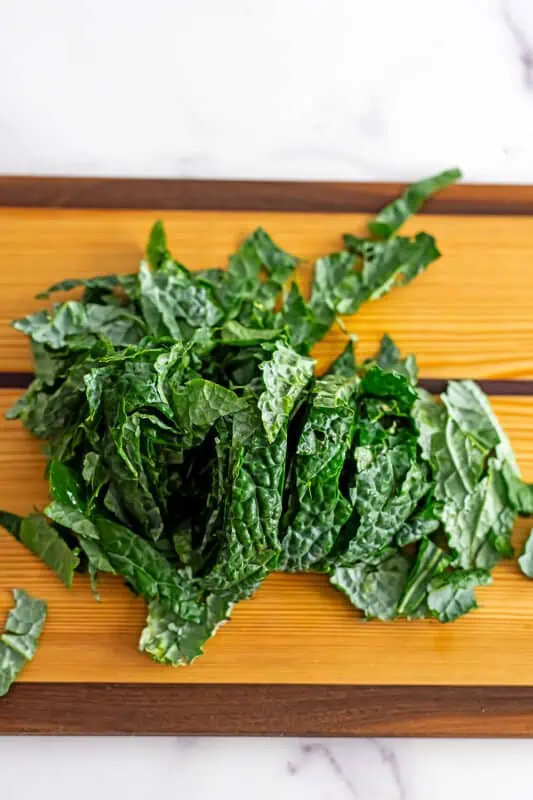 Kale on a wooden cutting board.