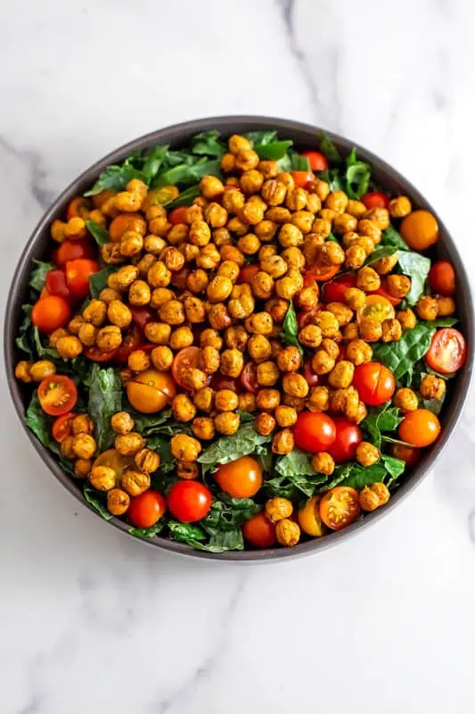 Kale tahini salad fully assembled in a gray bowl.