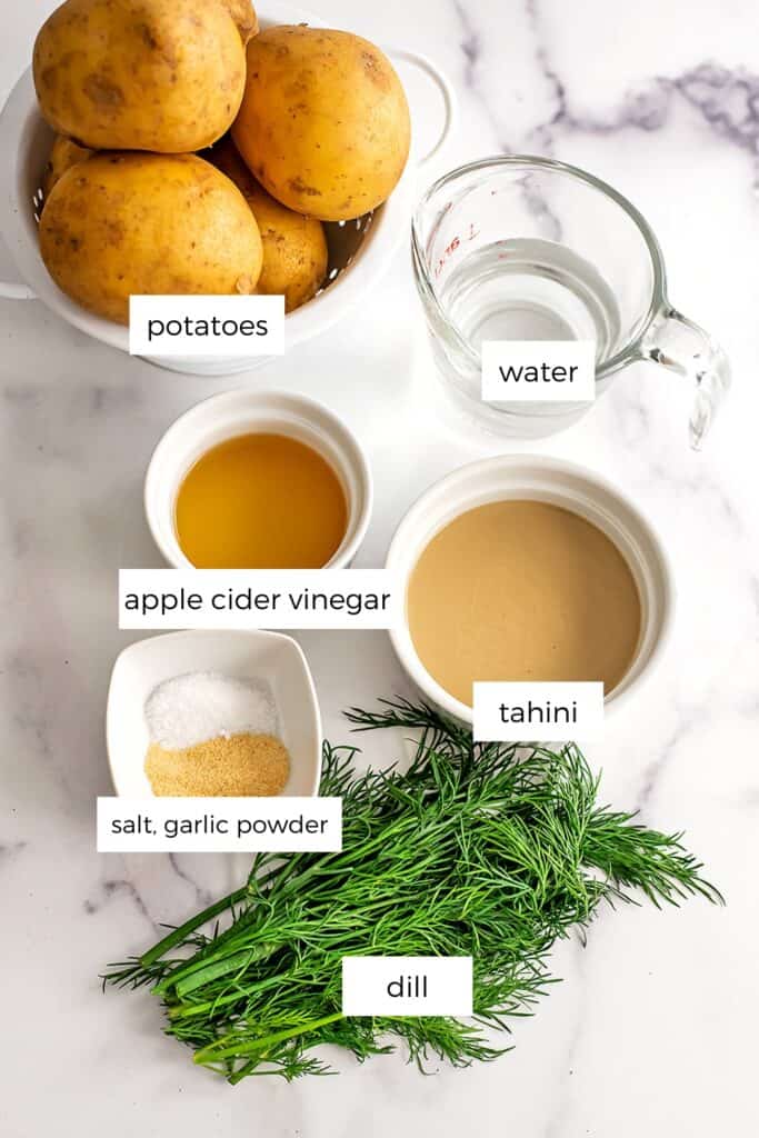 Vegan dill potato salad ingredients in white ramekins.