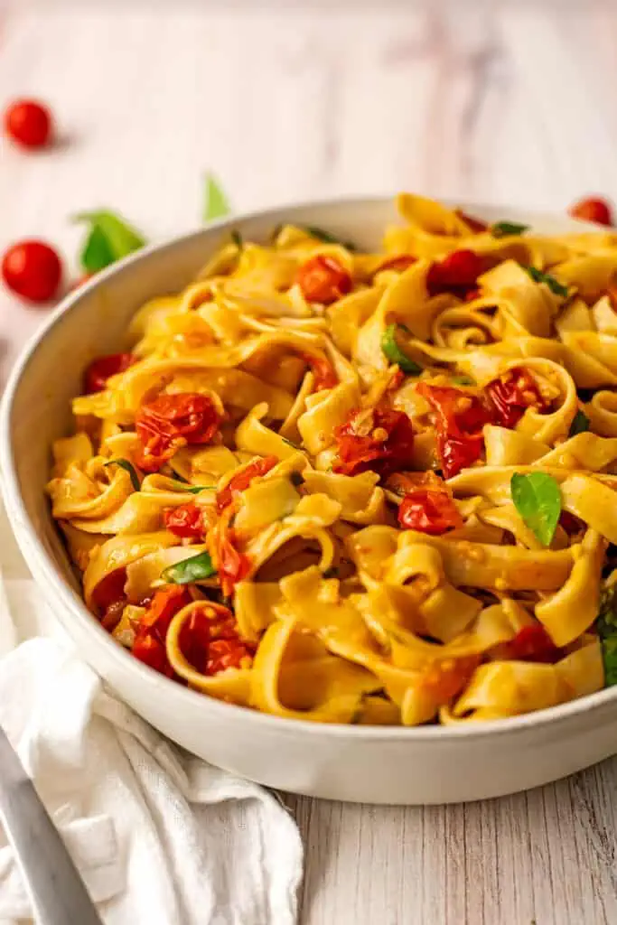 Cherry tomato pasta in a large white serving dish.