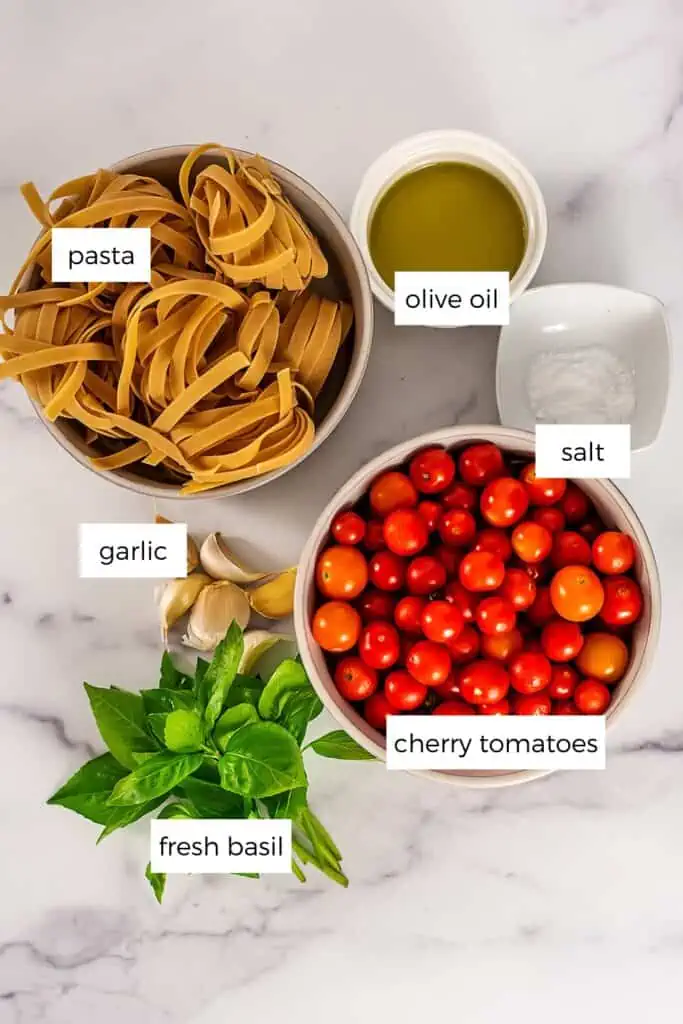 Cherry tomato pasta sauce ingredients in white ramekins.