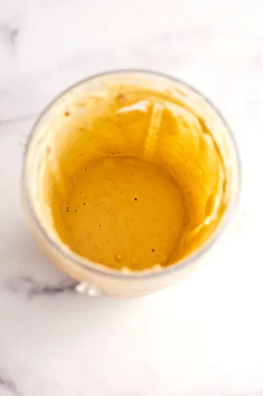 Cookie dough smoothie bowl in a blender cup after being blended.