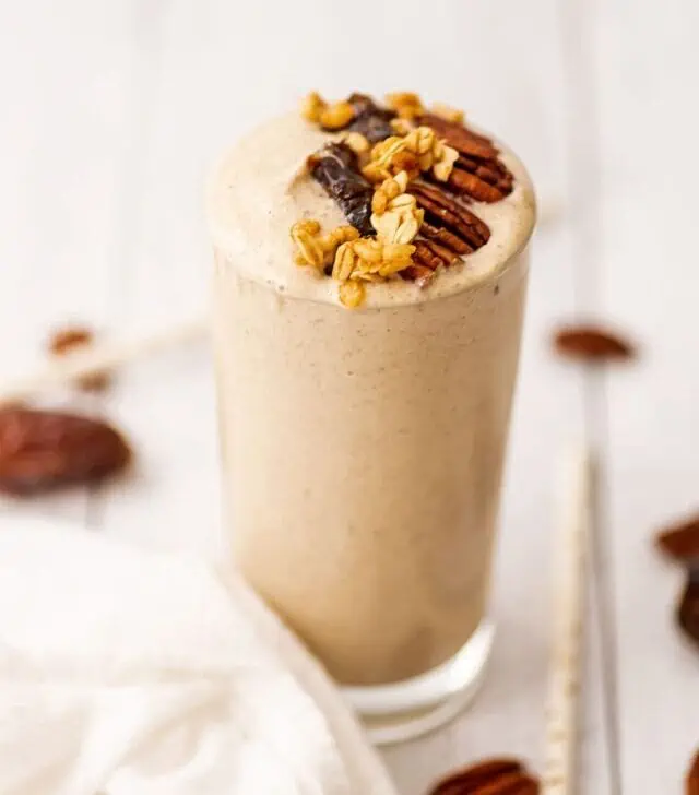 Pecan pie smoothie with pecans, dates, and granola on top.