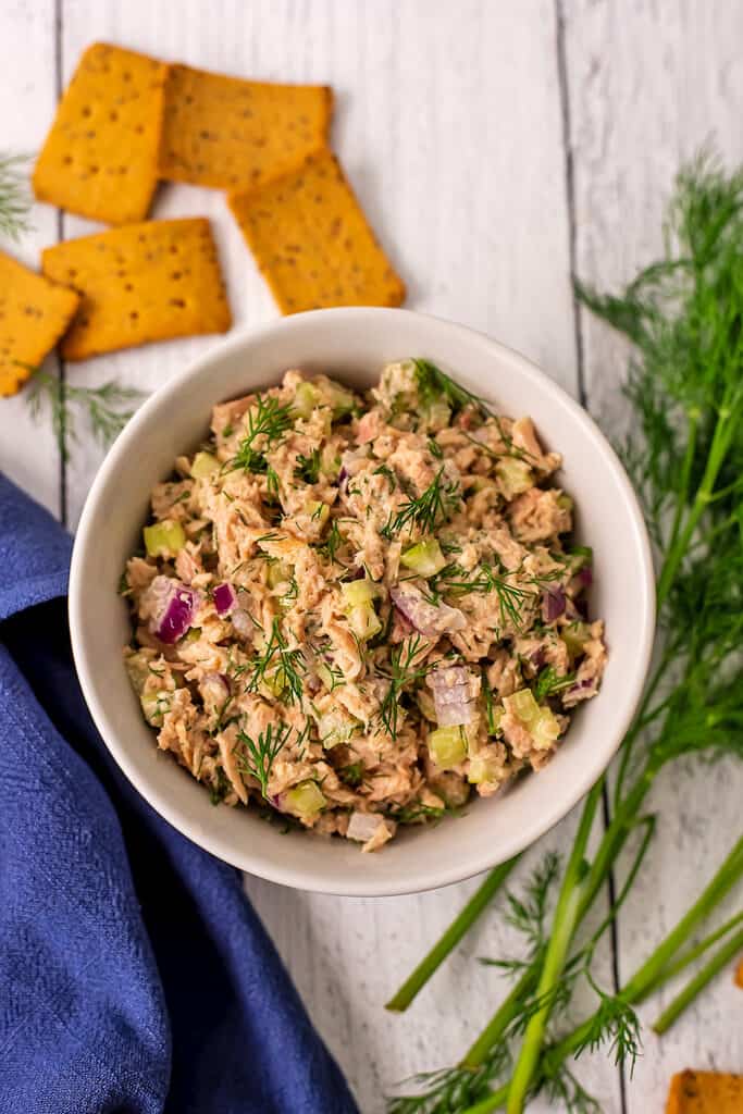 Dill tuna salad in a bowl served with crackers.