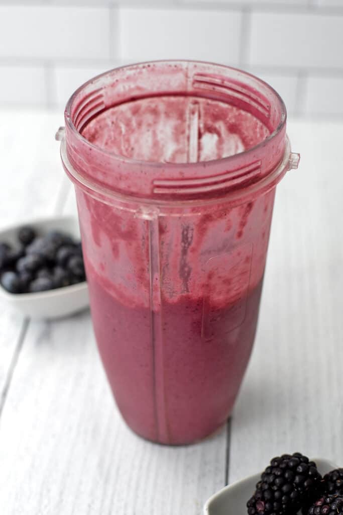 Meal prepped smoothie ice cubes blended in a blender cup.