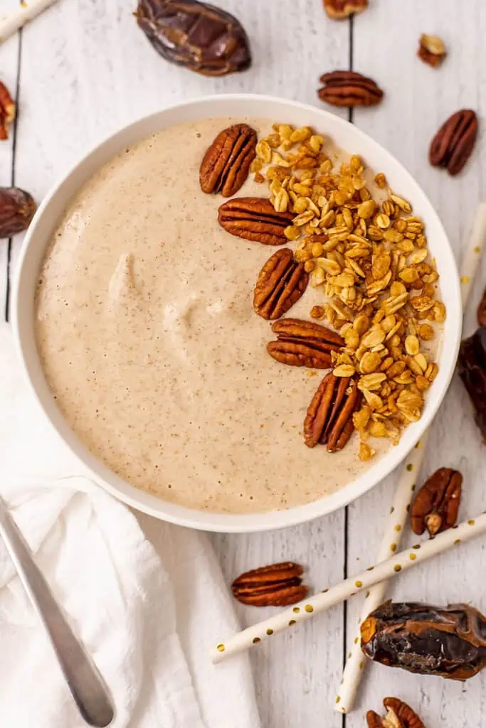 Pecan pie smoothie bowl topped with pecans and granola.