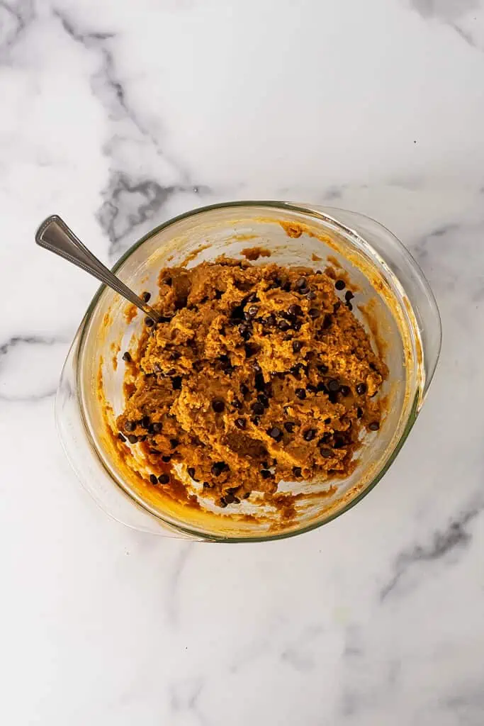 Protein powder cookie dough in a glass mixing bowl.