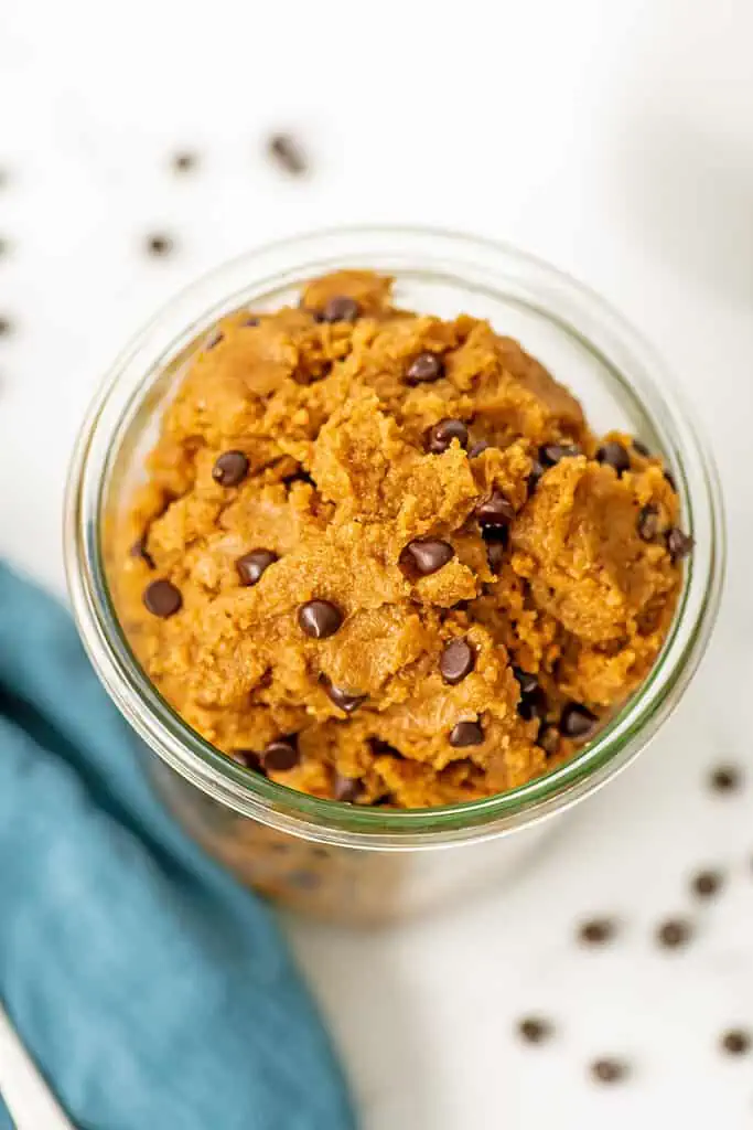 protein cookie dough in a large glass container.