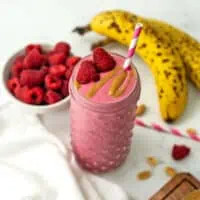 Raspberry peanut butter smoothie with peanut butter drizzle.